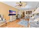 Inviting living room with a ceiling fan, comfortable seating, and entertainment center next to the dining area at 6021 Bahia Del Mar Cir # 234, St Petersburg, FL 33715