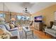 Comfortable living room with stylish furnishings, a ceiling fan, and sliding glass doors leading to a balcony at 6021 Bahia Del Mar Cir # 234, St Petersburg, FL 33715