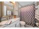 Bright bathroom featuring a marble countertop vanity and a shower with a patterned curtain at 632 Addison Ne Dr, St Petersburg, FL 33716