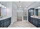 Elegant bathroom with double vanities, a walk-in shower, stylish fixtures, and plenty of natural light at 632 Addison Ne Dr, St Petersburg, FL 33716