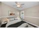 Comfortable bedroom featuring a ceiling fan, neutral walls, and natural light from a window at 632 Addison Ne Dr, St Petersburg, FL 33716