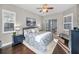 Cozy primary bedroom featuring a ceiling fan, a sliding glass door to the lanai, and neutral tones at 632 Addison Ne Dr, St Petersburg, FL 33716