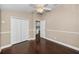 Spacious bedroom with hardwood floors, a ceiling fan, and a closet for ample storage at 632 Addison Ne Dr, St Petersburg, FL 33716