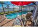 Inviting screened-in pool area featuring brick pavers and comfortable lounge chairs, perfect for relaxing and enjoying the Florida sunshine at 632 Addison Ne Dr, St Petersburg, FL 33716