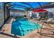 Screened-in pool with lounge chairs, a red umbrella, and well-maintained landscaping at 632 Addison Ne Dr, St Petersburg, FL 33716