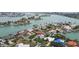 Aerial view of a waterfront community with canals, docks, and residences surrounded by lush greenery at 8000 13Th S Ave, St Petersburg, FL 33707