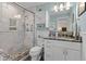 Bathroom featuring a glass-enclosed walk-in shower, a toilet, and a white vanity with marble countertop at 8000 13Th S Ave, St Petersburg, FL 33707