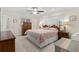 Bedroom features a king bed with a ceiling fan, two side tables, and a wooden dresser at 8000 13Th S Ave, St Petersburg, FL 33707