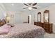 Spacious bedroom features a king size bed with ceiling fan, two closets, and hardwood floors at 8000 13Th S Ave, St Petersburg, FL 33707
