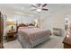 Bright bedroom featuring a king size bed, ceiling fan, and two side tables with lamps at 8000 13Th S Ave, St Petersburg, FL 33707