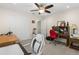 Bedroom with a ceiling fan, closet, and workstation with an office chair and computer setup at 8000 13Th S Ave, St Petersburg, FL 33707