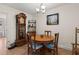 Cozy dining room featuring a wooden table with seating for four, adjacent to a vintage grandfather clock at 8000 13Th S Ave, St Petersburg, FL 33707