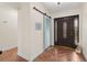 Inviting entryway featuring tile floors, a sliding barn door, and a decorative stained-glass front door at 8000 13Th S Ave, St Petersburg, FL 33707