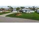Charming single-story home with a well-manicured lawn and circular garden bed in the front yard at 8000 13Th S Ave, St Petersburg, FL 33707