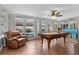 Billiards room features a pool table, an armchair, natural light and tile flooring at 8000 13Th S Ave, St Petersburg, FL 33707