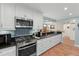 Well-lit kitchen featuring stainless steel appliances, granite countertops, and mosaic tile backsplash at 8000 13Th S Ave, St Petersburg, FL 33707