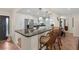 Open kitchen features a breakfast bar with granite countertops and bar stool seating at 8000 13Th S Ave, St Petersburg, FL 33707