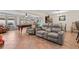 Spacious living room featuring a billiards table, sofas, tile floors and natural lighting at 8000 13Th S Ave, St Petersburg, FL 33707