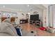 Cozy living room with a TV, sectional sofa, and access to the kitchen at 8000 13Th S Ave, St Petersburg, FL 33707