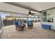 Covered and screened patio featuring a tiled floor, ceiling fan, and comfortable seating arrangement at 8000 13Th S Ave, St Petersburg, FL 33707