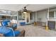 Inviting covered patio area with a ceiling fan, neutral color scheme, and comfortable seating at 8000 13Th S Ave, St Petersburg, FL 33707