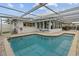 Private screened pool with a tile border and an open-air structure, perfect for relaxation at 8000 13Th S Ave, St Petersburg, FL 33707