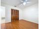 Bright bedroom features wood-look floors, a ceiling fan and closet with louvered doors at 808 Smith Bay Dr, Brandon, FL 33510