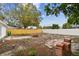 Spacious backyard featuring a new wooden fence, white fence, partial patio, and a large tree at 8930 94Th Ave, Seminole, FL 33777