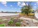 Spacious backyard featuring a new wooden fence, white fence, partial patio, and a large tree at 8930 94Th Ave, Seminole, FL 33777