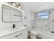 Bathroom features modern vanity, black fixtures, white marble tile at 8930 94Th Ave, Seminole, FL 33777