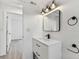 Bathroom with mirror, modern vanity, black fixtures, and hall access at 8930 94Th Ave, Seminole, FL 33777
