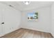 Bright room with wood-look floors, window with backyard view, and white door at 8930 94Th Ave, Seminole, FL 33777