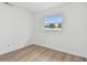 Bright bedroom with wood-look floors and a window providing natural light and backyard views at 8930 94Th Ave, Seminole, FL 33777