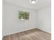 Bedroom with hardwood floors and a large window at 8930 94Th Ave, Seminole, FL 33777