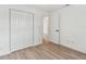 Bright bedroom features wood-look floors, large closet, and access to the rest of the home at 8930 94Th Ave, Seminole, FL 33777