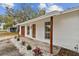 Charming single story home with a new gray roof, red door, and a well-maintained front yard at 8930 94Th Ave, Seminole, FL 33777