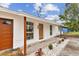 Charming single story home with a new gray roof, red door, and a well-maintained front yard at 8930 94Th Ave, Seminole, FL 33777