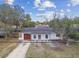 Charming single-story home with a well-kept lawn and inviting front entrance and an attached garage at 8930 94Th Ave, Seminole, FL 33777