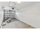 Garage has bare concrete floors, white-painted walls, and garage door at 8930 94Th Ave, Seminole, FL 33777