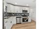 Updated kitchen features stainless steel appliances, white cabinets, and subway tile backsplash at 8930 94Th Ave, Seminole, FL 33777