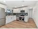 Updated kitchen features stainless steel appliances, white cabinets, and subway tile backsplash at 8930 94Th Ave, Seminole, FL 33777