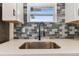 Close up of new stainless steel sink, black faucet, and decorative subway tile backsplash at 8930 94Th Ave, Seminole, FL 33777