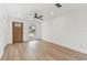 Living room featuring wood flooring, fresh paint, and natural light from the window at 8930 94Th Ave, Seminole, FL 33777