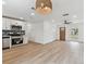 Open layout connecting living space to kitchen, with new flooring and modern appliances at 8930 94Th Ave, Seminole, FL 33777