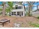 Backyard view of the two-story house with patio, screened in area, and fire pit at 9811 Memorial Hwy, Tampa, FL 33615