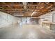 Unfinished basement with block walls, concrete floor and exposed wood supports at 9811 Memorial Hwy, Tampa, FL 33615