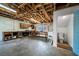 Unfinished basement with concrete floor, workbench, and adjacent half bath at 9811 Memorial Hwy, Tampa, FL 33615
