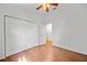 This neutral bedroom has wood floors, a ceiling fan, and a double door closet at 9811 Memorial Hwy, Tampa, FL 33615