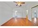 This bedroom features hardwood floors, a ceiling fan, and entrances to other rooms at 9811 Memorial Hwy, Tampa, FL 33615