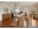 Open concept dining and kitchen area with hardwood floors, a ceiling fan and modern lighting at 9811 Memorial Hwy, Tampa, FL 33615